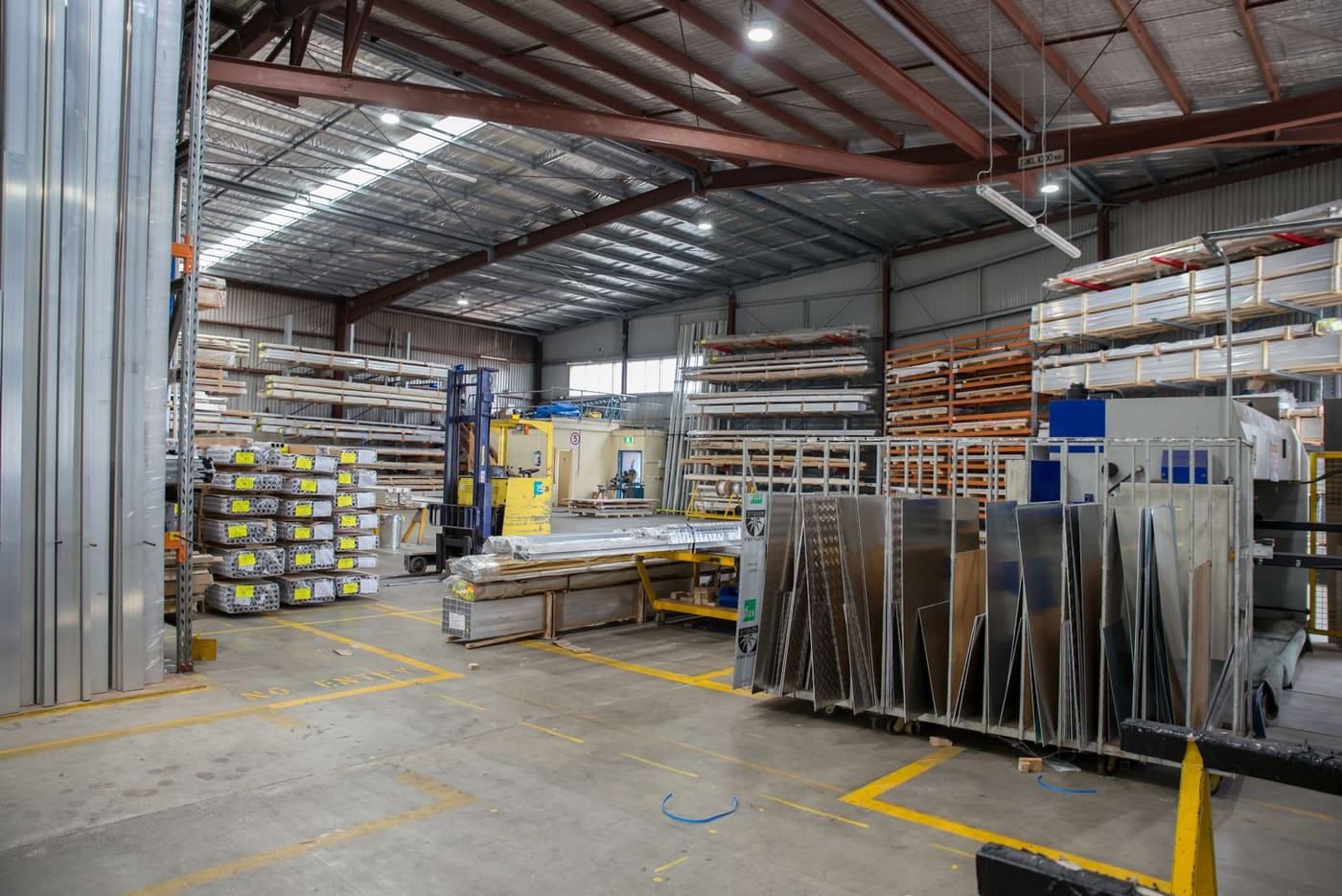 A large industrial interior with high ceilings and racking